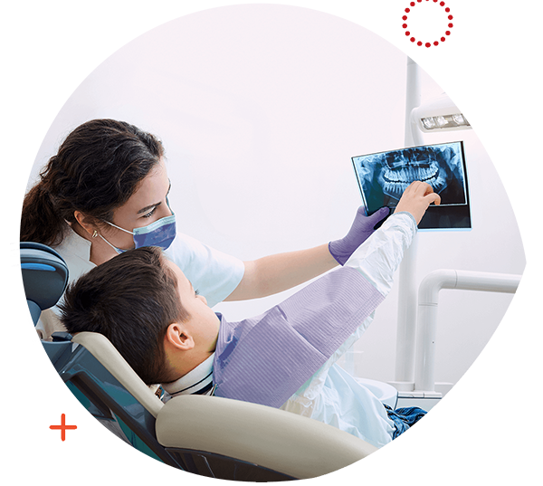 Young boy looking at his x-rays with a dental hygienist.