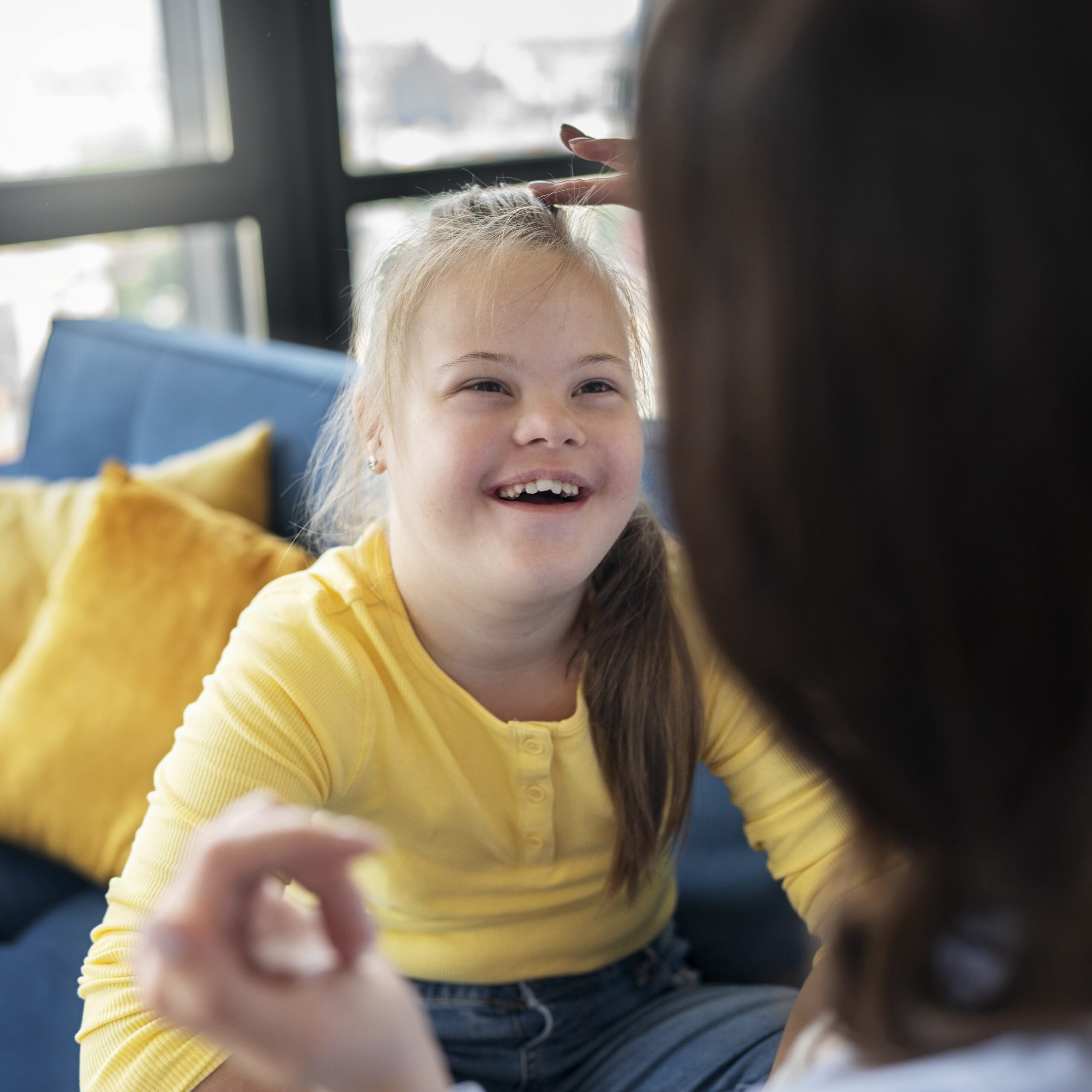 Image by Freepik. Special needs child smiling.
