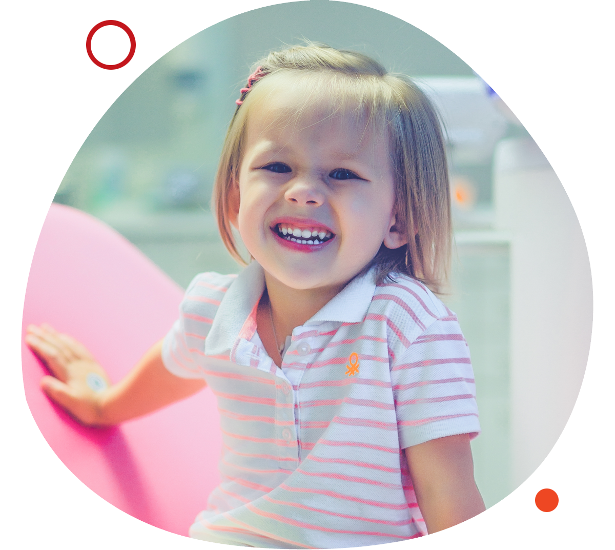Image by Freepik. Young girl smiling and sitting on the dental chair.
