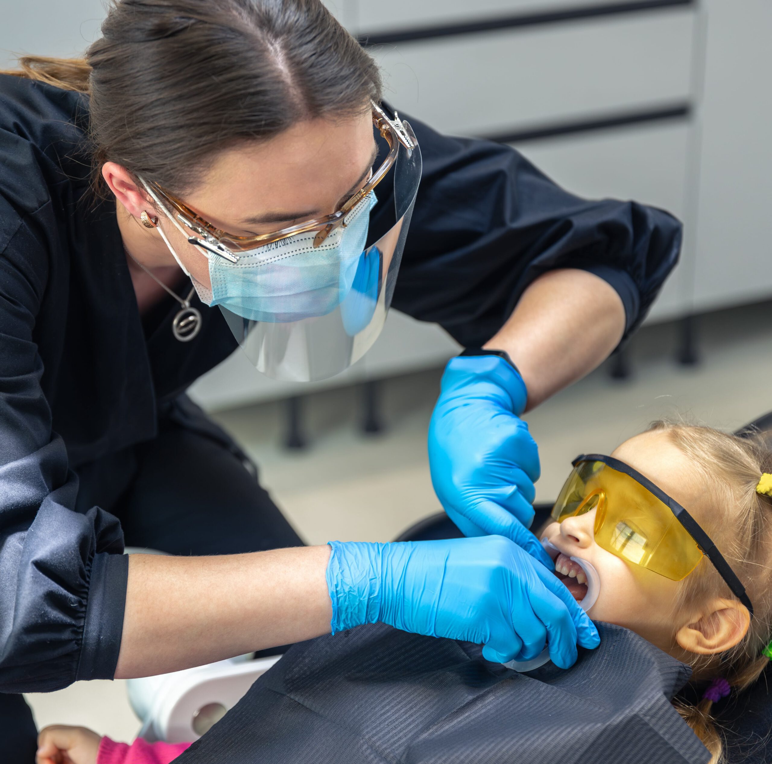 Dentist working on a child's teeth.